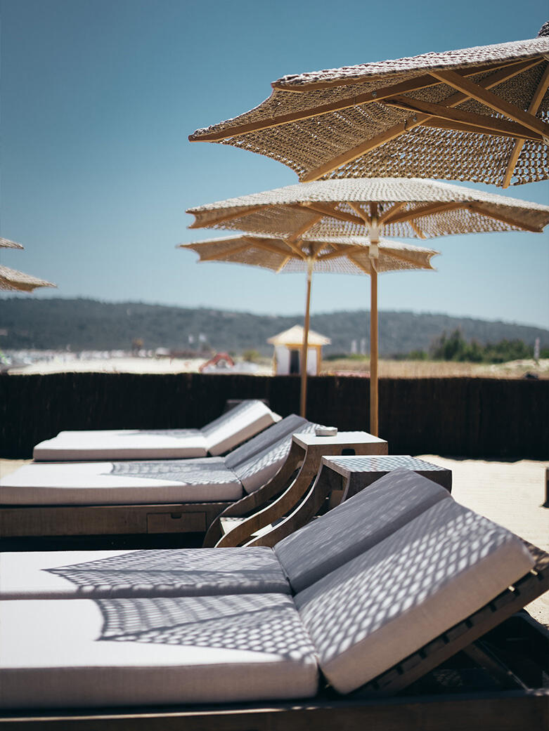 Luxury resort setting with sun loungers and parasols, representing hospitality real estate